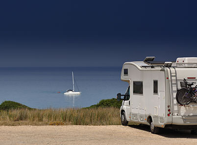 RV camping by the beach near a boat